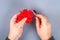 Red handmade diy monster pom pom from yarn, chenille stems in shape heart