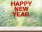 Red happy new year wood word hanging over marble table top with