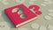 Red hardcover book with question symbol deeply engraved on it. Concept of mystery, curiosity and puzzle.