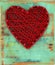 Red hart shape on Valentines day over vintage green wooden background