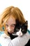 Red head girl holding a black white kitten