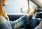 Red head lady driving a car with red nails detail closeup