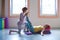 Red head pregnant young woman on yoga class with instructor