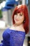 Red head young woman portrait in the street, red hair female openair in blue dress