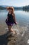 Red headed adult woman at Lake Siskiyou in Mount Shasta in Northern California, lands a jump in the lake