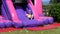 Red headed boy having fun playing on bouncy castle
