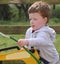 Red headed boy playing with water and toys in garden