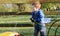 Red headed boy playing with water and toys in garden