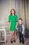 Red headed mother wearing green dress and son