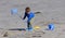 Red headed playing with a fishing net on sandy beach in Ireland