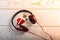 Red headphones, key and music written red heart  on wooden background