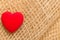 Red heart on abstract cloth background