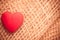 Red heart on abstract cloth background