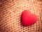 Red heart on abstract cloth background