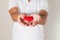 red heart in asian man hands,health- medicine and charity concept