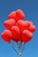 Red heart balloons flying in the skies