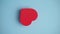 The red heart on the blue background. Valentine's day, love, wedding, romance concept. Minimal art creative video with