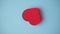 The red heart on the blue background. Valentine's day, love, wedding, romance concept. Minimal art creative video with