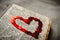 Red heart on the book on the textured background