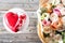 Red heart cacke desserts and bouquet of flowers on wooden background. dessert for breakfast on Valentine`s Day