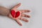 Red heart on a child s hand split into two, a quarrel concept. copyspace for text