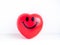 Red heart. Close-up happy smiley face on big red heart ball on white clean table