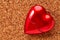 red heart on corkboard