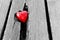 Red heart in crack of wooden plank. Symbol of love
