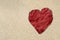 Red heart crumpled paper on sand texture, beach lover texture background