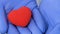 Red heart in doctors palms, organ transplantation, love and humanity, donation