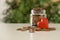 Red heart and donation jar with coins on table against blurred background