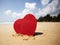 Red heart on exotic sandy beach