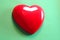 Red heart on green background, Showed  attention, unity, charity, care or love of human