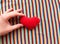 Red heart in hand on a background of rainbow fabric. place for text. bright banner, concept. love. copy space