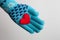 Red heart in hand in warm glove for Valentines Day