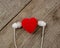 Red heart with headphones on wooden background with copy space. The concept of couple, lover, music, melody, relaxation, romance