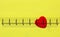 Red heart with heart waveon bright yellow background,