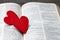 The red heart on holy bible book is the symbol of love from God. The God gives love to all people. We can see or find bible at the