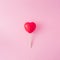 Red heart with ice cream stick on pastel pink background. Love creative concept.