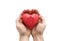 Red heart with imprinted house shape in man`s hands.