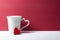 Red heart leaning white mug. Valentines concept.
