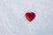 Red heart lies on the snow, the symbol of Valentine`s Day