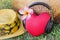 Red heart listen to music via headphone with pink flower frangipani or plumeria and summer hat and bag in background with relax f