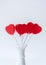 Red heart lollipops in white vase with white background