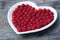 Red heart made of raspberry.