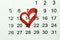 Red heart marked on a calendar, concept for an important day.  Valentines day concept.