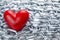 Red heart on metal chains background