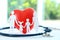 Red heart model, stethoscope and paper family cutout