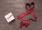 Red heart necktie is on wooden background