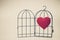 A red heart in opened bird cage